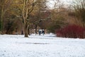 Jette, Brussels, Belgium - Local people walking through the snow in the city park