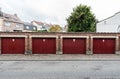 Jette, Brussels Capital Region - Belgium - Four garage ports in a row in a residential area with a no parking sign