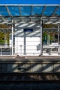 Jette, East Flemish Region, Belgium - Hard shadows at the platform and tracks of the local railway station