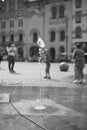 The jetting of the fountain in the city square.