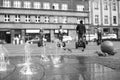 The jetting of the fountain in the city square.