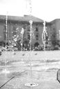 The jetting of the fountain in the city square.