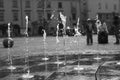 The jetting of the fountain in the city square.