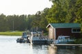 Jetty with boatshed and moored leisureboats Finland