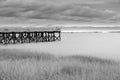 Jetty on Calf Pasture Beach Connecticut under overcast sky in moody monochrome