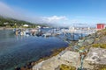 The jetty of Kvalsund village in Norwegian Finnmark.  The pier is at foreground and the coastline of Kvalsund bay is at background Royalty Free Stock Photo