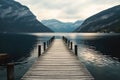 Jetty on lake. Wooden jetty on quiet lake with mountains in background. Lake has dark blue color, and mountains are covered with Royalty Free Stock Photo
