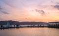 Jetty with people and sailboat silhouette during sunset Royalty Free Stock Photo