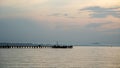 Jetty pier deck. sunset lake. purple and orange sky. A wooden pier at sunset. The pier is made of wooden planks and has a railing