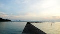 Jetty pier deck. sunset lake. purple and orange sky. A wooden pier at sunset. The pier is made of wooden planks and has a railing