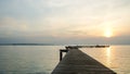 Jetty pier deck. sunset lake. purple and orange sky. A wooden pier at sunset. The pier is made of wooden planks and has a railing