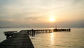 Jetty pier deck. sunset lake. purple and orange sky. A wooden pier at sunset. The pier is made of wooden planks and has a railing