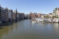 Jetty with pleasure ships on Damrak street in the center of Amsterdam