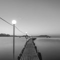 Jetty on sea at dawn. Black and white