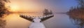 Jetty on a still lake on a foggy winter`s morning