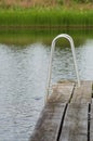 Jetty walkway pier with stairs to the lake Royalty Free Stock Photo