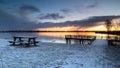 Jetty and wooden picnic table by Lake Dirkshorn in a winter setting. Royalty Free Stock Photo