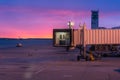 Jetway Doors on and Airport Runway at Sunrise with Flight Control Tower in the Background