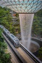 Jewel Changi Airport Skytrain running along rain vortex waterfall, Singapore.