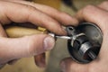 Jeweler adjusts precious stones in a gold ring Royalty Free Stock Photo