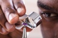 Jeweler Examining Diamond Through Loupe Royalty Free Stock Photo