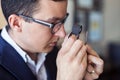 Jeweler examining diamond through loupe Royalty Free Stock Photo