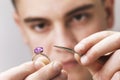 Jeweler inspects a gold ring with a large amethyst