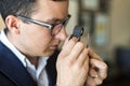 Jeweler looking at diamond through loupe Royalty Free Stock Photo