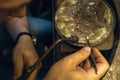 A jeweler melts a gold piece in the process of repair