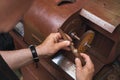 A jeweler polishes a gold ring on a machine in a workshop, a working process