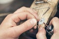 Jeweler polishes a gold ring with a special tool. Workflow in the workshop