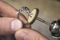 Jeweler polishes a gold ring in the workshop