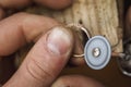 The jeweler polishes the golden ring with a special tool