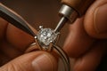A jeweler sets a sparkling diamond in a ring using handheld tools, demonstrating detailed craftsmanship and precision work Royalty Free Stock Photo