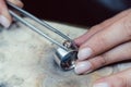 Jeweler setting a precious stone with pincers on a ring