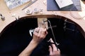 Jeweler at work in jewelery workshop, woman hands making silver thing. tools set Royalty Free Stock Photo