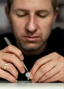 Jeweler working on a ring with stones