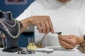A jeweler in a workshop is working on a ring. Ring in the hands of a jeweler Royalty Free Stock Photo