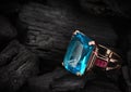 Jewelery ring with aquamarine gemstone on dark coal background,