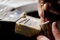 Jeweller handmade work, crafting golden jewellery with tools, closeup