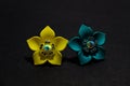 Jewellery artifact yellow,blue  flowers design earrings on black shadow background. Royalty Free Stock Photo