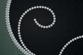 Jewellery curling diamonds on dark pattern background. 3D rendering