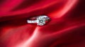 Jewellery, proposal and holiday gift, diamond engagement ring on red silk satin fabric, symbol of love, romance and commitment Royalty Free Stock Photo