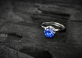 Jewellery ring witht big blue sapphir on dark coal background, s Royalty Free Stock Photo