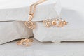 Jewellery set of hearts shape rose gold ring, pendant necklace and stud earrings on white background Royalty Free Stock Photo