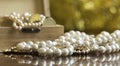 Jewelries, white pearls with treasure chest on golden background