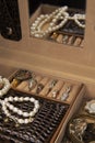 Jewelry box with different rings, earrings and pendants with pearls. Royalty Free Stock Photo