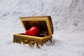 Jewelry box with a heart inside. Painted wooden box for decoration with gold rings inside. Soft fluffy backgroundr. Royalty Free Stock Photo