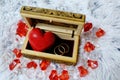 Jewelry box with a heart inside. Painted wooden box for decoration with gold rings inside. Soft fluffy backgroundr. Royalty Free Stock Photo