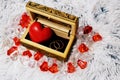 Jewelry box with a heart inside. Painted wooden box for decoration with gold rings inside. Soft fluffy backgroundr. Royalty Free Stock Photo